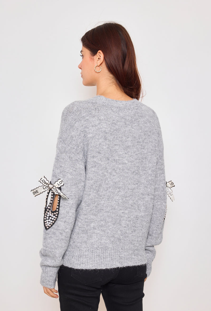 Sweater with ribbons and rhinestones on the sleeves