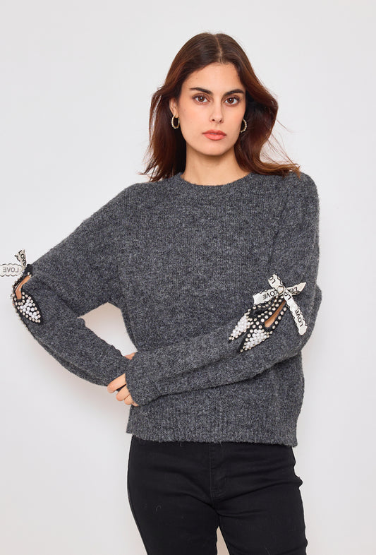 Sweater with ribbons and rhinestones on the sleeves