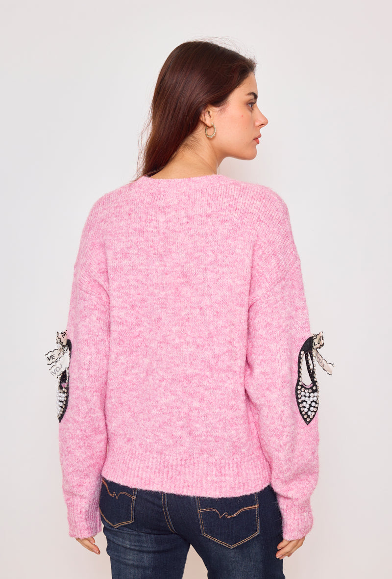 Sweater with ribbons and rhinestones on the sleeves