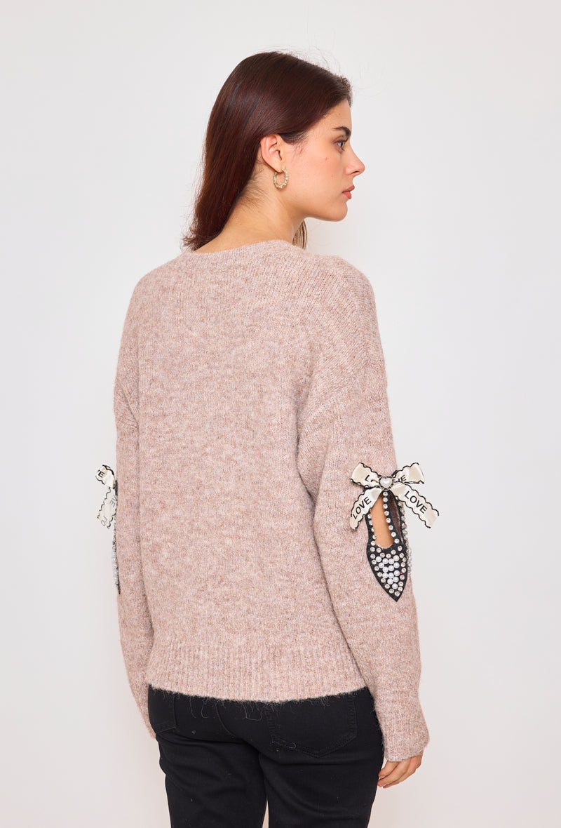 Sweater with ribbons and rhinestones on the sleeves