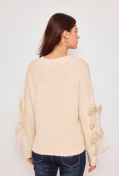 Sweater with ribbons and rhinestones on the sleeves