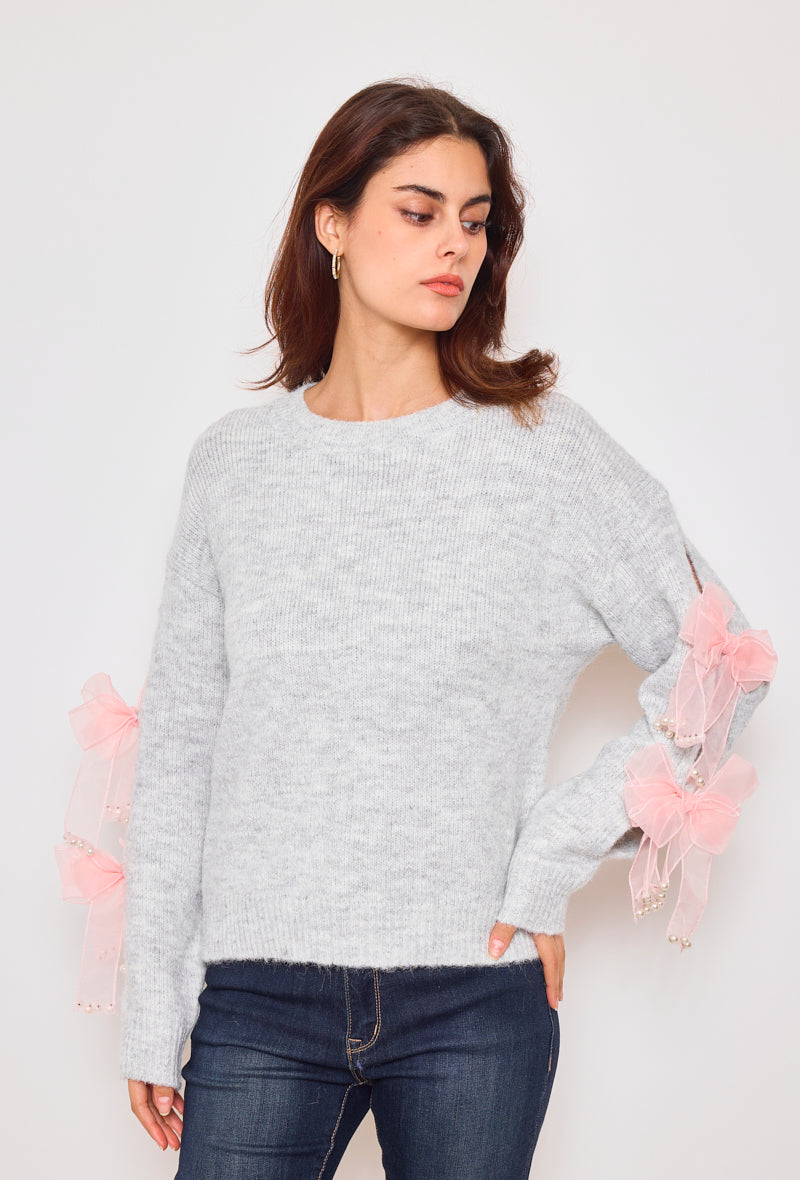 Sweater with ribbons and rhinestones on the sleeves