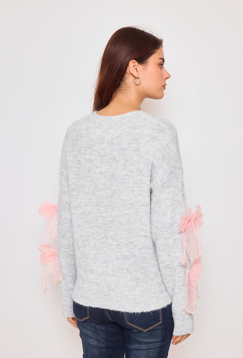 Sweater with ribbons and rhinestones on the sleeves