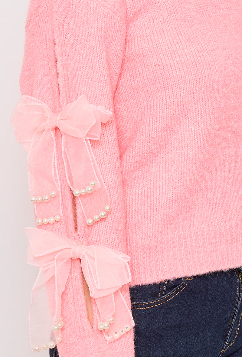 Sweater with ribbons and rhinestones on the sleeves